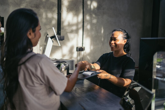 Waitress processing payments in a modern cafe