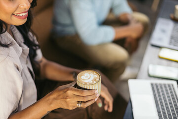 Close up of a female hand holding a cup of coffee