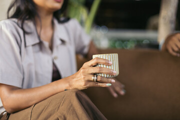 Female hand holding a cup of coffee