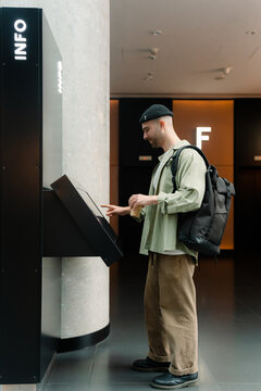 A man uses an electronic scoreboard in a shopping mall
