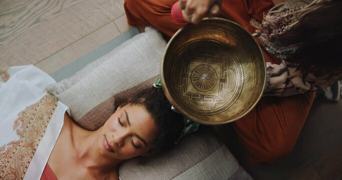 Meditation, singing bowl and woman on floor with healer for sound therapy, vibration or chakra balance from above. Healing, soul or female person with shaman for energy, cleaning or holistic care