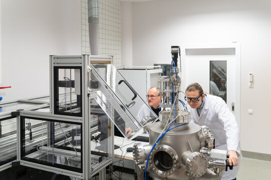 Scientists Working With Pulsed Laser Deposition System