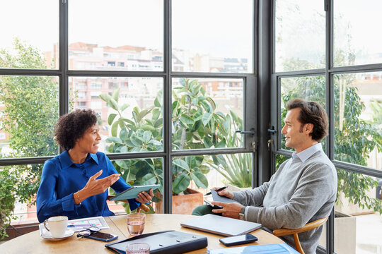 Diverse colleagues discussing business issues in office