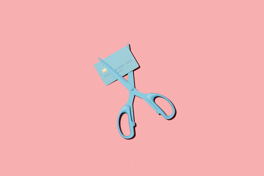 Scissors cutting debit / credit card. Reduce / pay off debt concept.