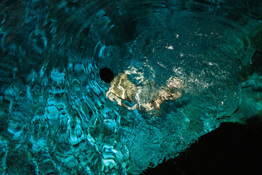 Underwater shot of man diving in Mexican cenote