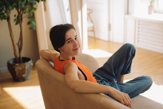 Woman sitting on a couch at home