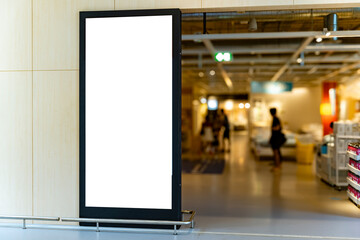 Mockup vertical blank billboard with black frame at front of shoes shop