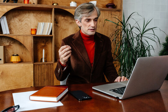 Businessman participates in video chat at office