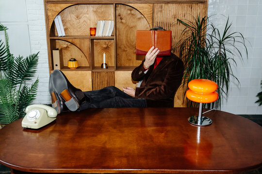 Businessman relaxing in 70's style office