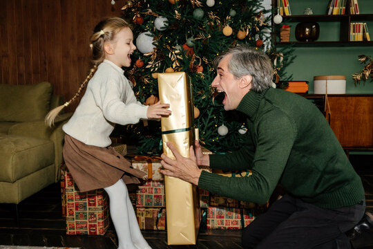 Father and daughter with gifts at Christmas time
