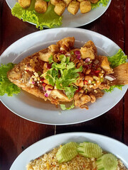 fried spicy tilapia fish on table