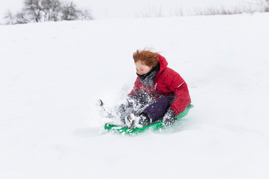 Boy tobogganing