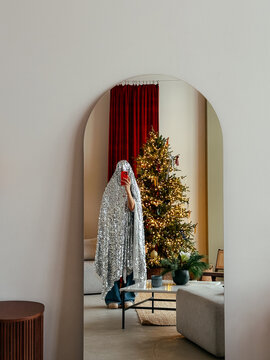 Woman covered with tinsel taking selfie