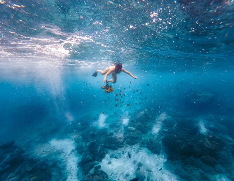 Woman Snorkeling In The Blue Sea
