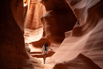 Woman walking through a narrow canyon in Arizona