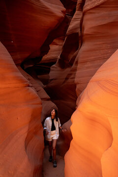 Woman walking through a narrow canyon in Arizona