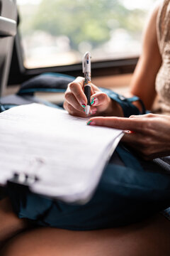 Woman writing on papers.