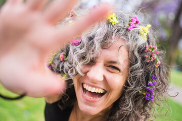 Happy woman with natural hair with flowers