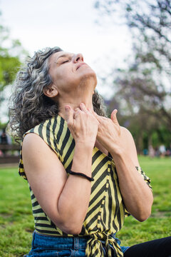 Woman applying sun blocker on neck