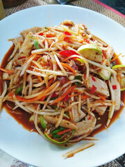 Thai food papaya salad with cabbage yard long bean on white plate