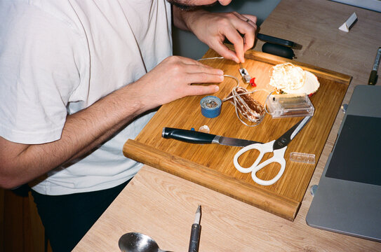 Anonymous young man fixing Christmas lights 