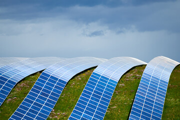 Ribbons of PV solar cells, curving shapes over mountain terrain
