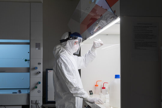 Researcher Holding Sample In Chamber At Clean Room 