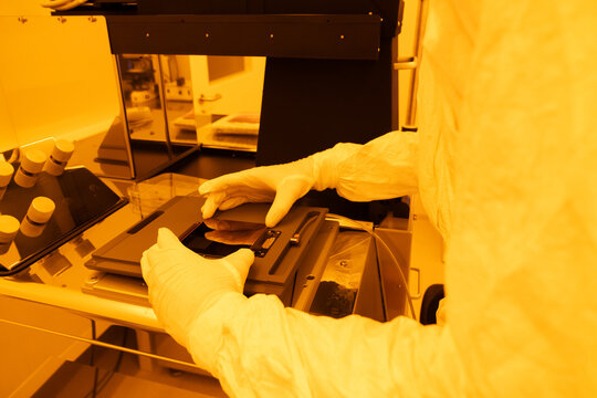 Scientist Working With Sample In Clean Room 