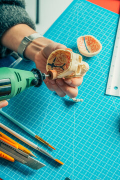 Hands working on skull miniature 