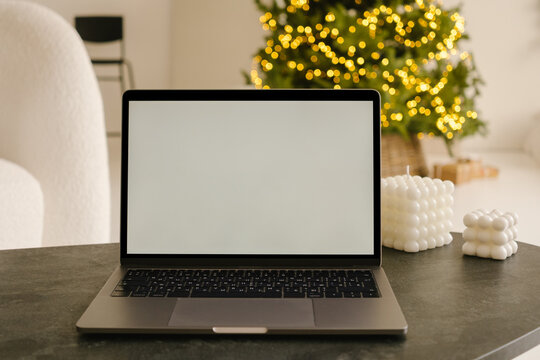 Laptop with empty screen placed on table in room