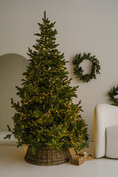 Christmas tree placed on hand woven wicker basket