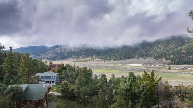 Clouds rolling over beautiful mountain landscape and country homes  in Fraizer Park, California. Timelapse.