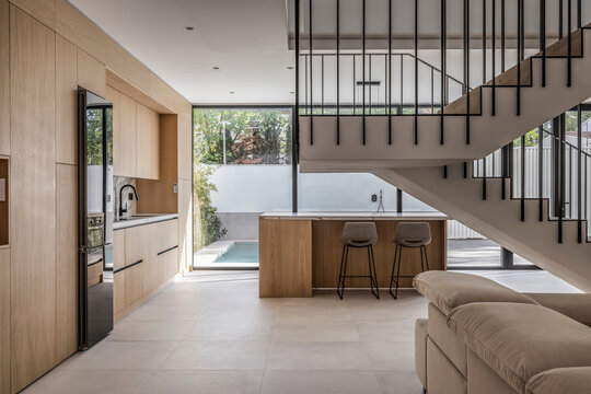 A sleek and spacious interior with a garden and swimming pool