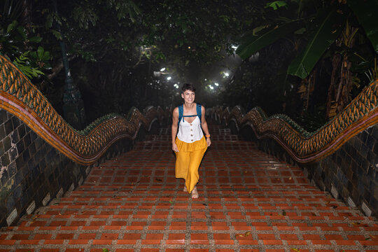 Woman at Naga stairs of Wat Doi Suthep.