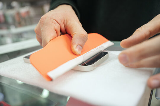 Man putting up a new mobile screen protector