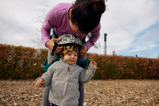 Mother equips her son for a bike ride