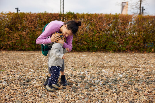 Mother prepares her son for biking