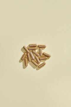 Top view of  brown pills or capsule isolated on light