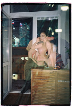Surreal double exposure portrait of a young women smoking near balcony
