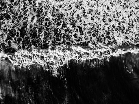 overhead aerial photo of ocean waves breaking
