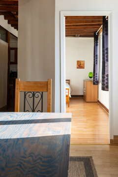 View of multiple rooms inside decorated apartment: kitchen and bedroom