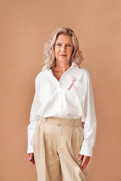 Confident senior woman with pink ribbon.