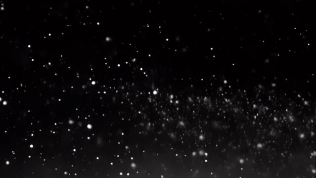 Snowflakes gently falling against dark black background, creating tranquil winter scene
