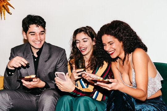 Friends looking at phone at a party