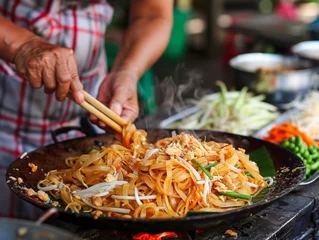 Fotobehang The perfect toss of Pad Thai a skill honed on the vibrant streets © WARIT_S