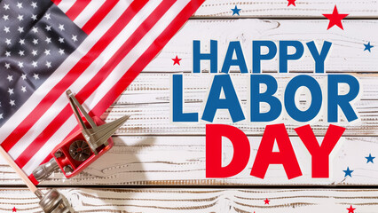 Labor Day greeting with American flag and miniature wheelbarrow on wooden background