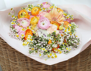 Close up image of xixed colorful flowers in basket.
