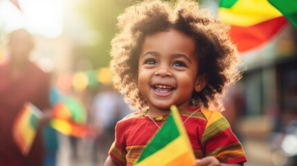 Happy Child Holding red, green and yellow flag symbolizing Juneteenth Freedom and African liberation day. Black life matters. Black history month. - obrazy, fototapety, plakaty