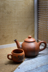 Teapots, teapots, places to brew and drink tea from terracotta, made traditionally, wooden background and natural wicker