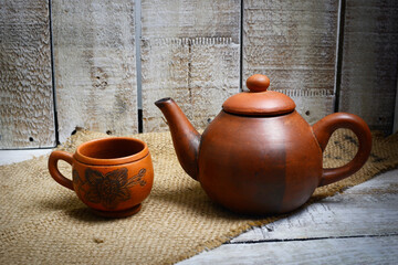 Teapots, teapots, places to brew and drink tea from terracotta, made traditionally, wooden background and natural wicker